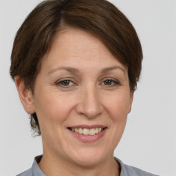 Joyful white adult female with short  brown hair and brown eyes