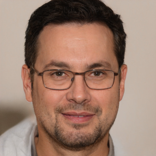 Joyful white adult male with short  brown hair and brown eyes