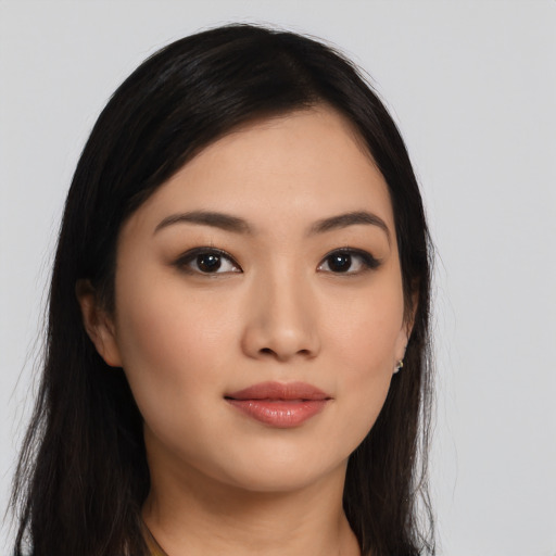 Joyful asian young-adult female with long  black hair and brown eyes