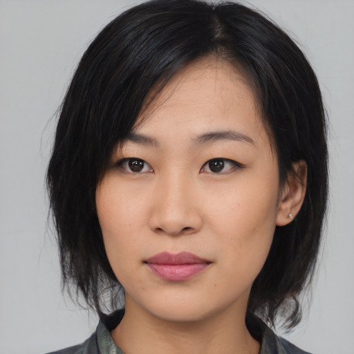 Joyful asian young-adult female with medium  black hair and brown eyes