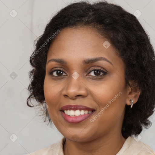 Joyful black young-adult female with long  brown hair and brown eyes