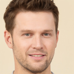 Joyful white young-adult male with short  brown hair and grey eyes