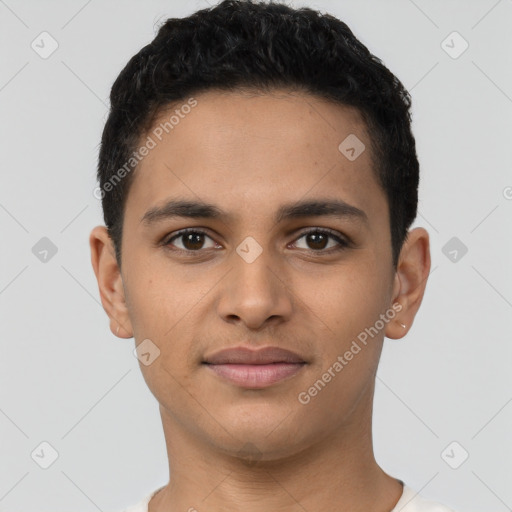 Joyful latino young-adult male with short  brown hair and brown eyes