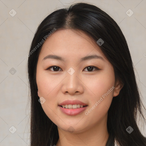 Joyful asian young-adult female with long  brown hair and brown eyes