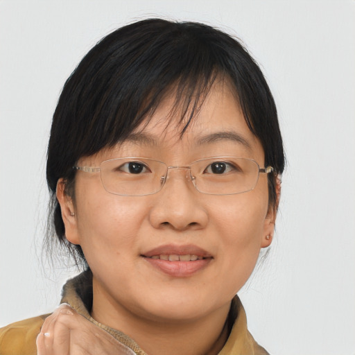 Joyful asian adult female with medium  brown hair and brown eyes