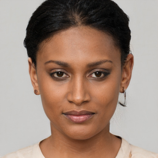 Joyful black young-adult female with short  brown hair and brown eyes