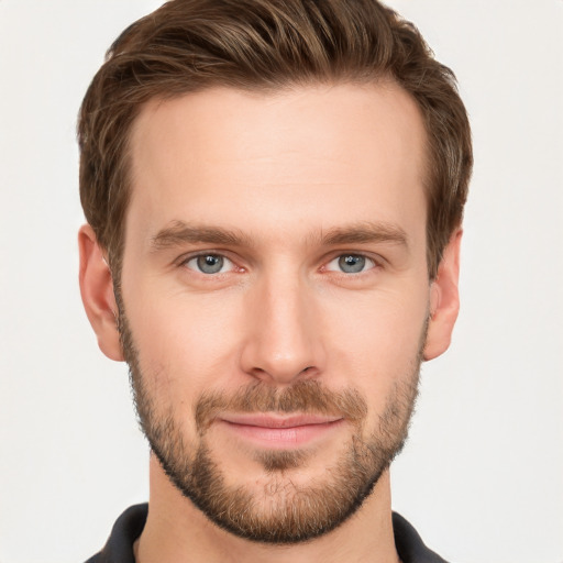 Joyful white young-adult male with short  brown hair and grey eyes