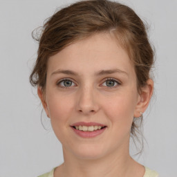 Joyful white young-adult female with medium  brown hair and green eyes