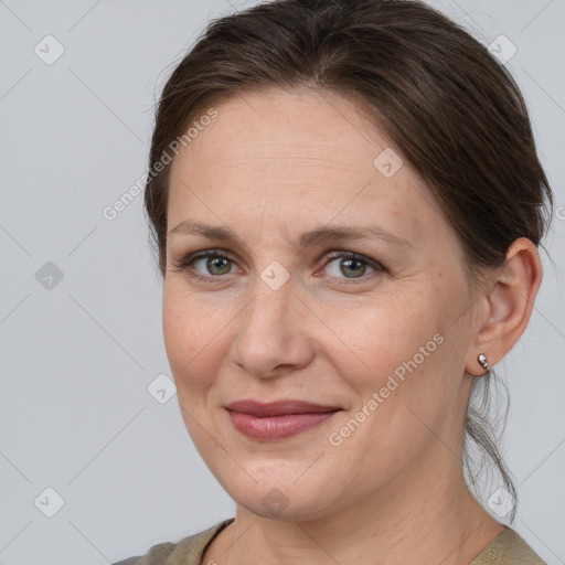 Joyful white adult female with medium  brown hair and brown eyes