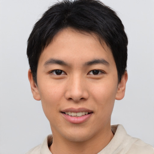 Joyful asian young-adult male with short  brown hair and brown eyes