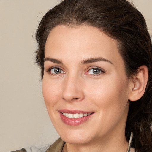 Joyful white young-adult female with medium  brown hair and brown eyes