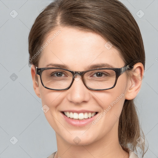 Joyful white young-adult female with medium  brown hair and grey eyes