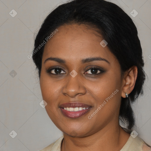 Joyful black young-adult female with long  black hair and brown eyes