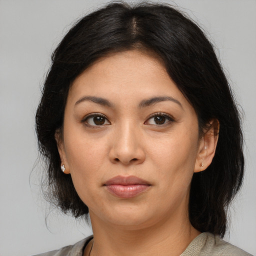 Joyful asian young-adult female with medium  brown hair and brown eyes