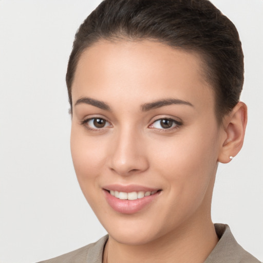 Joyful white young-adult female with short  brown hair and brown eyes