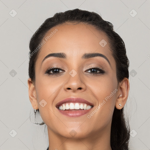 Joyful white young-adult female with long  black hair and brown eyes