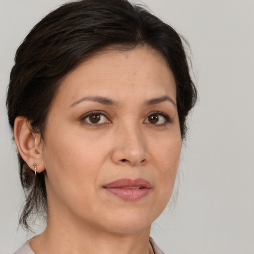 Joyful white adult female with medium  brown hair and brown eyes