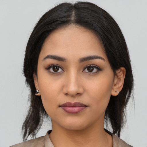 Joyful latino young-adult female with medium  black hair and brown eyes