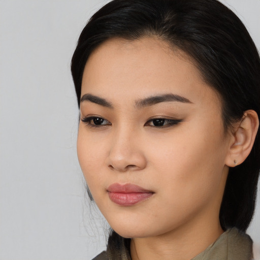 Joyful asian young-adult female with medium  black hair and brown eyes