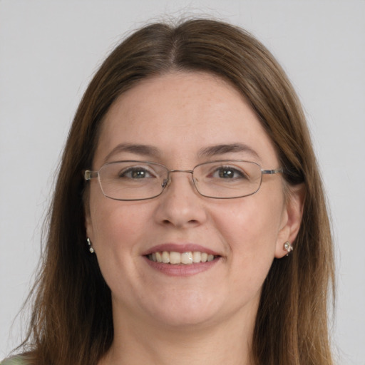 Joyful white young-adult female with long  brown hair and green eyes