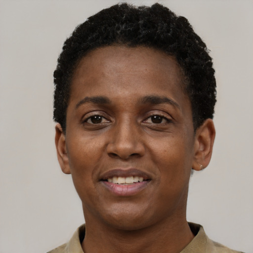 Joyful black young-adult female with short  black hair and brown eyes