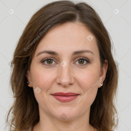 Joyful white young-adult female with long  brown hair and green eyes