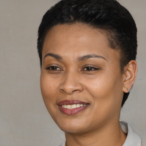 Joyful latino young-adult female with short  black hair and brown eyes