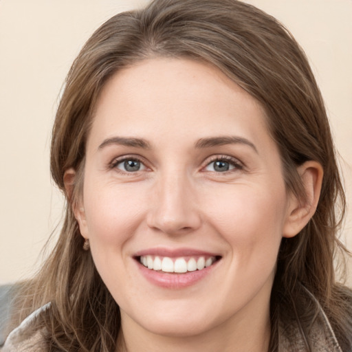 Joyful white young-adult female with long  brown hair and grey eyes