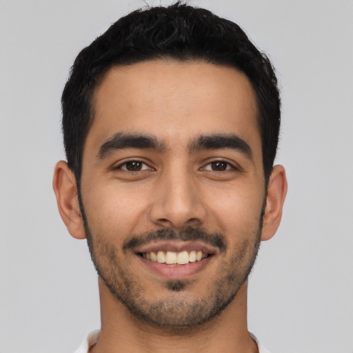 Joyful latino young-adult male with short  black hair and brown eyes