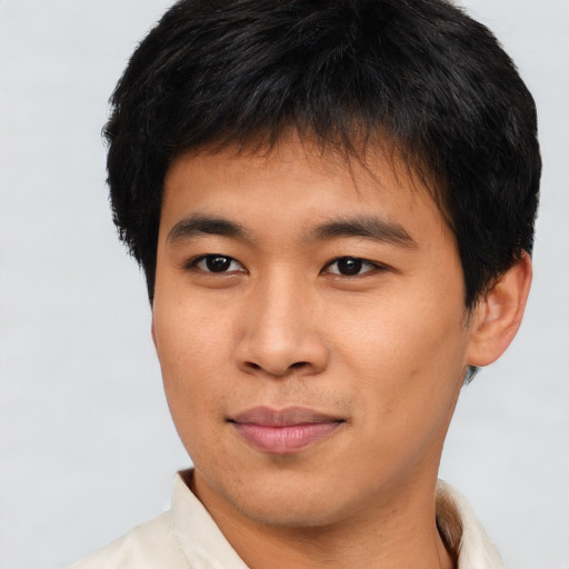 Joyful asian young-adult male with short  brown hair and brown eyes