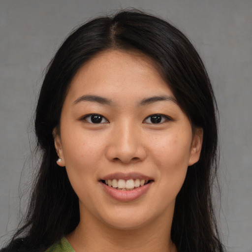 Joyful asian young-adult female with long  brown hair and brown eyes