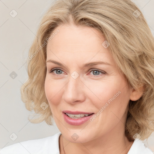 Joyful white adult female with medium  brown hair and blue eyes