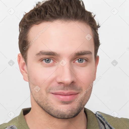 Joyful white young-adult male with short  brown hair and grey eyes