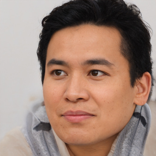 Joyful asian young-adult male with short  brown hair and brown eyes