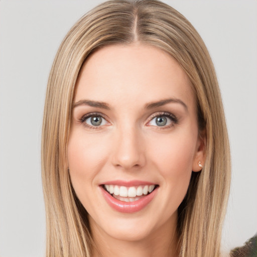 Joyful white young-adult female with long  brown hair and green eyes