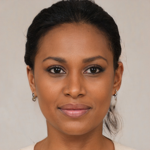 Joyful black young-adult female with medium  brown hair and brown eyes