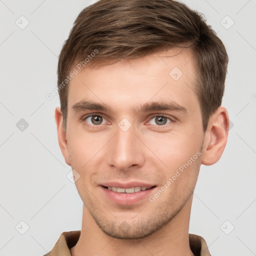 Joyful white young-adult male with short  brown hair and grey eyes