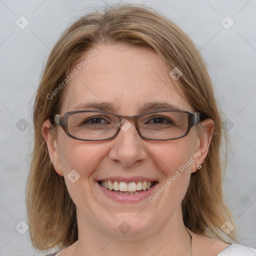 Joyful white adult female with medium  brown hair and blue eyes