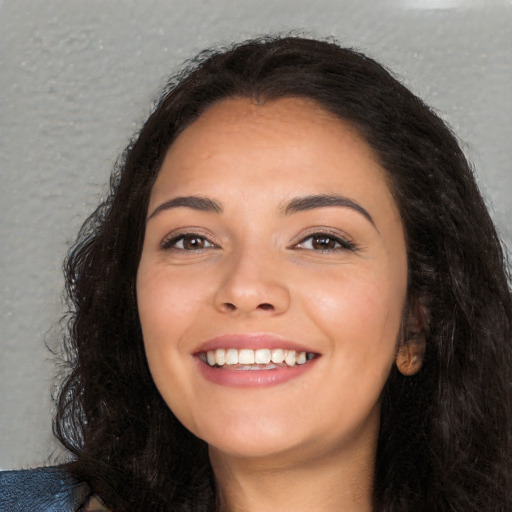 Joyful white young-adult female with long  black hair and brown eyes