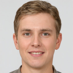 Joyful white young-adult male with short  brown hair and grey eyes