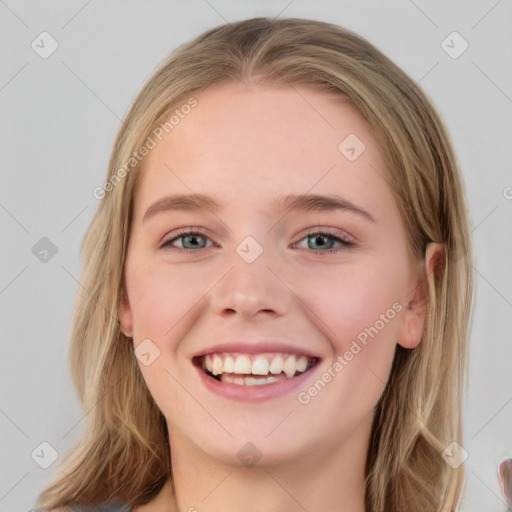 Joyful white young-adult female with long  brown hair and blue eyes