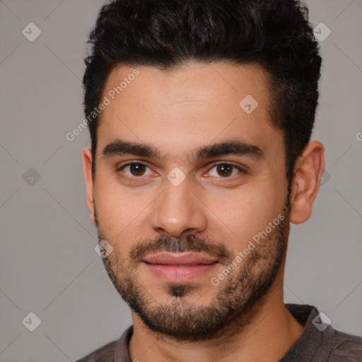 Joyful white young-adult male with short  black hair and brown eyes