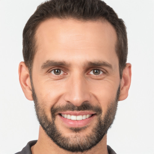 Joyful white young-adult male with short  brown hair and brown eyes