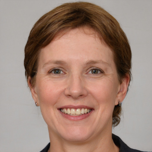 Joyful white adult female with medium  brown hair and blue eyes