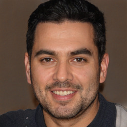 Joyful white young-adult male with short  black hair and brown eyes