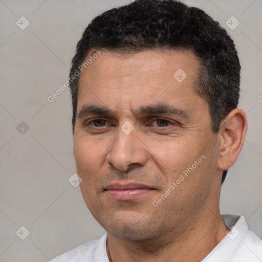 Joyful white adult male with short  black hair and brown eyes