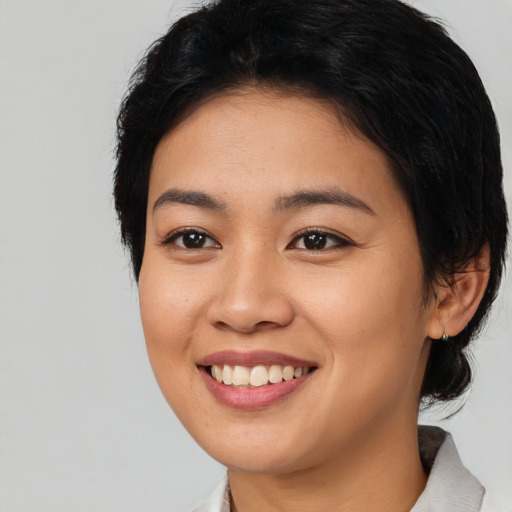 Joyful asian young-adult female with medium  black hair and brown eyes