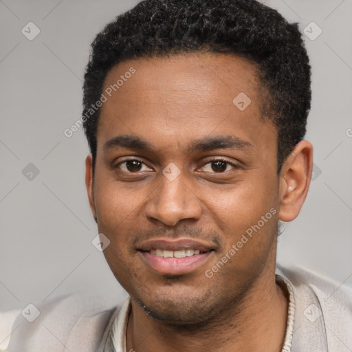 Joyful black young-adult male with short  black hair and brown eyes