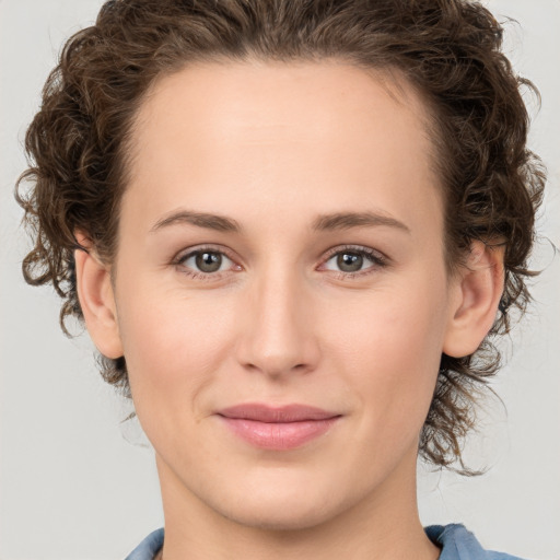 Joyful white young-adult female with medium  brown hair and green eyes