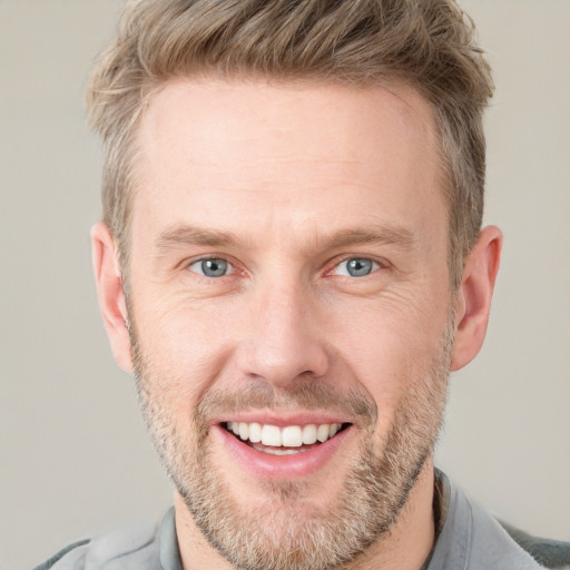 Joyful white adult male with short  brown hair and grey eyes